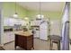 A fully functional kitchen with white appliances, an island, and bright lighting at 114 Tennyson Way, Summerville, SC 29486