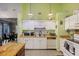 Cozy kitchen with white cabinetry, a center island, and matching appliances at 114 Tennyson Way, Summerville, SC 29486