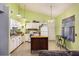 A fully functional kitchen with white appliances, an island, and bright lighting at 114 Tennyson Way, Summerville, SC 29486