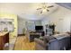 Open living room with couches, TV, fireplace and hardwood floors with lots of light at 114 Tennyson Way, Summerville, SC 29486