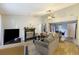 Bright living room features a fireplace, neutral walls, ceiling fan, and hardwood floors at 114 Tennyson Way, Summerville, SC 29486