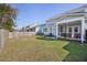 Fenced backyard with screened porch, patio seating, and green space for outdoor enjoyment at 1261 Gannett Rd, Mount Pleasant, SC 29464