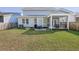 A backyard with a patio, a table with chairs, and a screened porch for outdoor relaxation at 1261 Gannett Rd, Mount Pleasant, SC 29464