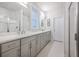 Bright bathroom featuring double vanity with gray cabinets and framed mirror, plus shower with glass door at 1261 Gannett Rd, Mount Pleasant, SC 29464