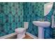 Powder room features modern sink, toilet, and bold palm wallpaper at 1261 Gannett Rd, Mount Pleasant, SC 29464