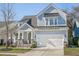 Beautiful two-story home featuring a welcoming front porch and a two-car garage at 1261 Gannett Rd, Mount Pleasant, SC 29464