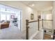 Hallway offers views into office, living room, and lower level, showcasing an open and airy floor plan at 1261 Gannett Rd, Mount Pleasant, SC 29464