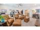Cozy living room featuring leather seating, ceiling fan, large windows, workspace, and a view of the hallway at 1261 Gannett Rd, Mount Pleasant, SC 29464