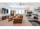 Spacious living room features a leather couch, ceiling fan, large windows, and a dedicated workspace at 1261 Gannett Rd, Mount Pleasant, SC 29464