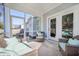Relaxing screened patio with wicker furniture and view of backyard at 1261 Gannett Rd, Mount Pleasant, SC 29464