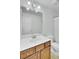 Bright bathroom with a white sink, wood vanity, and a mirror with overhead lighting at 1300 Carol Oaks Dr, Mount Pleasant, SC 29466