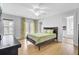 Bright bedroom featuring a ceiling fan, french doors, and an ensuite bathroom at 1300 Carol Oaks Dr, Mount Pleasant, SC 29466