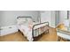 Comfortable bedroom with wood floors, black metal bedframe, and white bedside tables at 1300 Carol Oaks Dr, Mount Pleasant, SC 29466