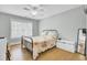 Bedroom with hardwood floors, a ceiling fan, and large window allowing ample natural light at 1300 Carol Oaks Dr, Mount Pleasant, SC 29466