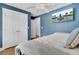 Blue bedroom with white trim featuring a large closet and a wall-mounted TV at 1300 Carol Oaks Dr, Mount Pleasant, SC 29466