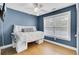 Cozy bedroom with blue walls, a ceiling fan, and a daybed by a window at 1300 Carol Oaks Dr, Mount Pleasant, SC 29466