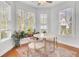 Bright breakfast nook with windows, hardwood floors, ceiling fan and decorative plants at 1300 Carol Oaks Dr, Mount Pleasant, SC 29466