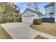 A detached one-car garage featuring light blue siding, white trim, and a neutral-colored driveway at 1300 Carol Oaks Dr, Mount Pleasant, SC 29466