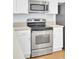 Close-up of the kitchen's stainless steel stove and microwave, paired with white cabinets at 1300 Carol Oaks Dr, Mount Pleasant, SC 29466