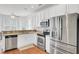 Well-lit kitchen with stainless steel appliances, white cabinetry, and hardwood floors at 1300 Carol Oaks Dr, Mount Pleasant, SC 29466