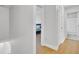 Upstairs landing features bedroom and bathroom access, with wood floors and neutral paint at 1300 Carol Oaks Dr, Mount Pleasant, SC 29466