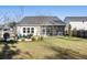 A beautifully landscaped backyard with a patio, screened porch, and well-maintained lawn, perfect for outdoor entertaining at 1403 Thin Pine Dr, Johns Island, SC 29455