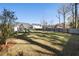 Large backyard with mature trees, a swing set, and privacy fence between neighboring homes at 1403 Thin Pine Dr, Johns Island, SC 29455