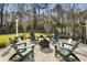 Backyard retreat with Adirondack chairs around a fire pit area, swing set, and mature trees at 1403 Thin Pine Dr, Johns Island, SC 29455