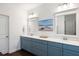 Modern bathroom with double vanity, framed mirrors, and stylish blue cabinetry at 1403 Thin Pine Dr, Johns Island, SC 29455