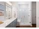 Elegant bathroom with a tiled shower, glass door, and stylish blue vanity at 1403 Thin Pine Dr, Johns Island, SC 29455