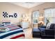 bedroom with red, white and blue décor, a comfortable chair, and light-filled windows at 1403 Thin Pine Dr, Johns Island, SC 29455