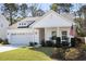 Charming single-Gathering home featuring a well-manicured lawn, inviting porch, and attached two-car garage at 1403 Thin Pine Dr, Johns Island, SC 29455