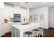 Bright kitchen with white cabinets, a functional island with seating, and attractive backsplash, perfect for cooking at 1403 Thin Pine Dr, Johns Island, SC 29455
