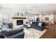 Open-concept living room with a fireplace, plush seating, and seamless flow into the kitchen at 1403 Thin Pine Dr, Johns Island, SC 29455