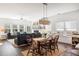 Spacious living and dining room offering an open layout with a fireplace and large windows for ample natural light at 1403 Thin Pine Dr, Johns Island, SC 29455