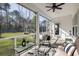 Relaxing screened porch overlooking a spacious backyard with lush greenery and a charming ambiance at 1403 Thin Pine Dr, Johns Island, SC 29455