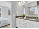 Double sink vanity with white cabinets, elegant mirrors, and modern fixtures at 151 Cantona Dr, Summerville, SC 29483