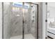 Marble-tiled shower with sleek glass doors, a built-in niche, and modern fixtures at 151 Cantona Dr, Summerville, SC 29483