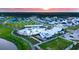 An aerial view shows the community and its luxurious pool, offering resort-style living with sunset at 1601 Trailmore Ln, Summerville, SC 29486