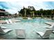 Relax and unwind in the community pool with its comfortable lounge chairs and tropical ambiance at 1601 Trailmore Ln, Summerville, SC 29486