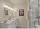 Bright bathroom features a modern vanity with white countertop and stylish black and white patterned floor at 1600 Long Grove Dr # 1621, Mount Pleasant, SC 29464