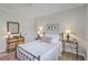 Cozy bedroom with a wrought iron bed, hardwood floors, and stylish bedside lamps at 1600 Long Grove Dr # 1621, Mount Pleasant, SC 29464