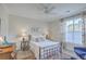 Serene bedroom featuring a wrought iron bed, hardwood floors, and a large window with custom drapes at 1600 Long Grove Dr # 1621, Mount Pleasant, SC 29464