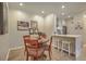 Cozy dining area with wood table, decorative art, and breakfast bar adjacent to the kitchen at 1600 Long Grove Dr # 1621, Mount Pleasant, SC 29464