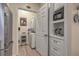 Convenient laundry area with stackable washer/dryer, storage cabinets, and adjacent stainless refrigerator at 1600 Long Grove Dr # 1621, Mount Pleasant, SC 29464