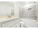 Modern bathroom with stylish tile, a large vanity, and shower/tub combo at 1630 Balsam St, Charleston, SC 29407