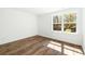 Bright bedroom features wood floors and a large window with natural light at 1630 Balsam St, Charleston, SC 29407