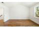 Bright bedroom boasts wood floors, vaulted ceilings, and a large window with natural light at 1630 Balsam St, Charleston, SC 29407