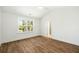 Spacious bedroom boasts a large window, wood floors, and a ceiling fan at 1630 Balsam St, Charleston, SC 29407