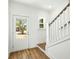 Inviting entryway with a white door, staircase and wood flooring at 1630 Balsam St, Charleston, SC 29407
